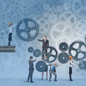 An illustration of various businesspeople and workers managing oversized gears and sprockets