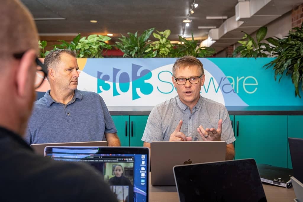 Denver app development company discusses a new software project with clients.